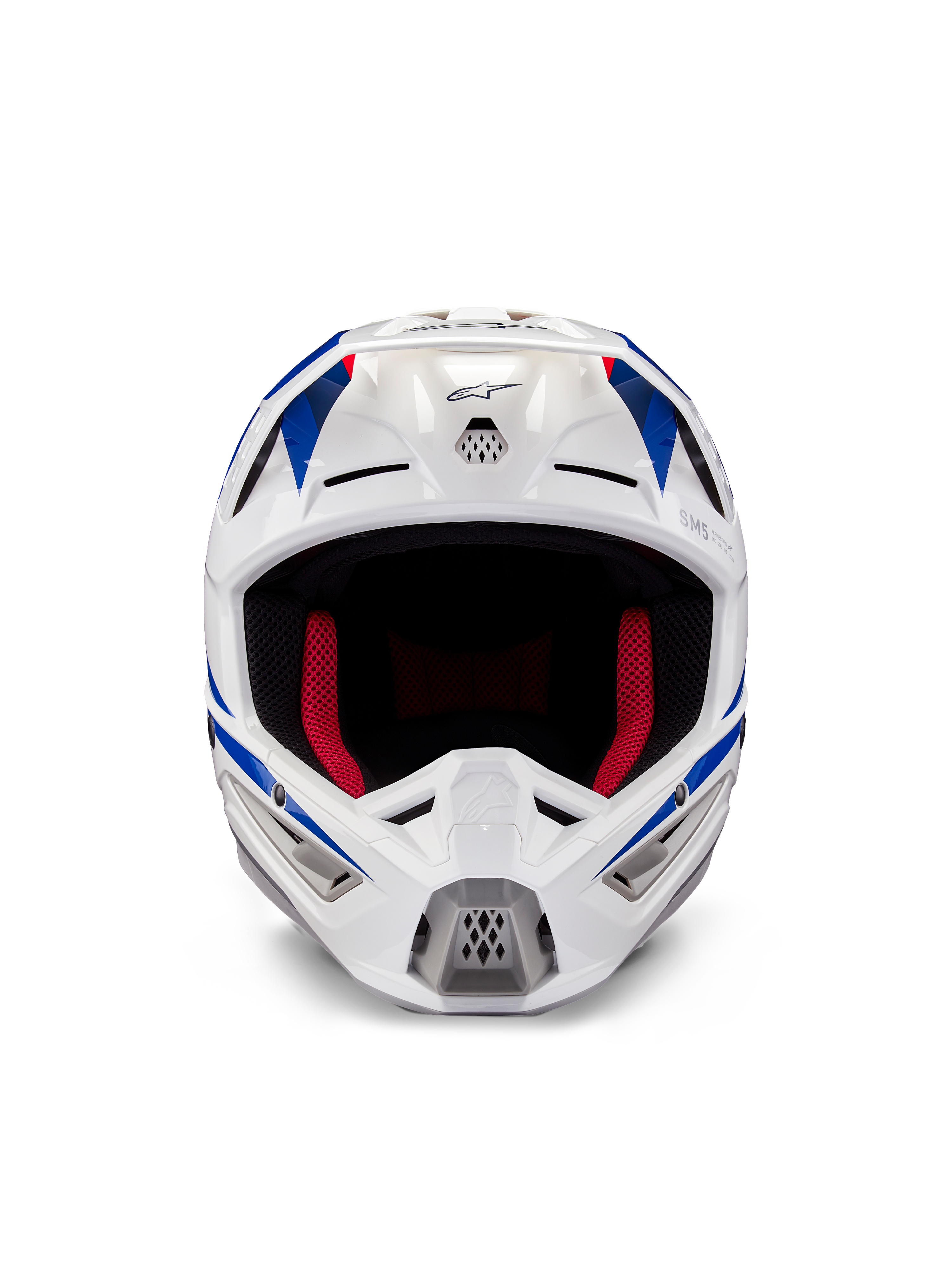 Capacete Alpinestars Honda S-M5 ECE, capacete de motocross, branco, azul e vermelho brilhante, vista frontal mostrando as aberturas de ventilação e o forro interno vermelho, design aerodinâmico para proteção em competições de todo-o-terreno