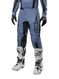 Alpinestars 2024 Fluid Lurv Pants, Motocross Pants, Light Blue and Black, worn with matching long-sleeve jersey and white motocross boots, featuring a prominent black star logo on the thigh and reinforced inner knee panels, front view on white background