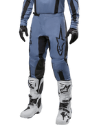 Alpinestars 2024 Fluid Lurv Pants, Motocross Pants, Light Blue and Black, worn with matching long-sleeve jersey and white motocross boots, featuring a prominent black star logo on the thigh and reinforced inner knee panels, front view on white background