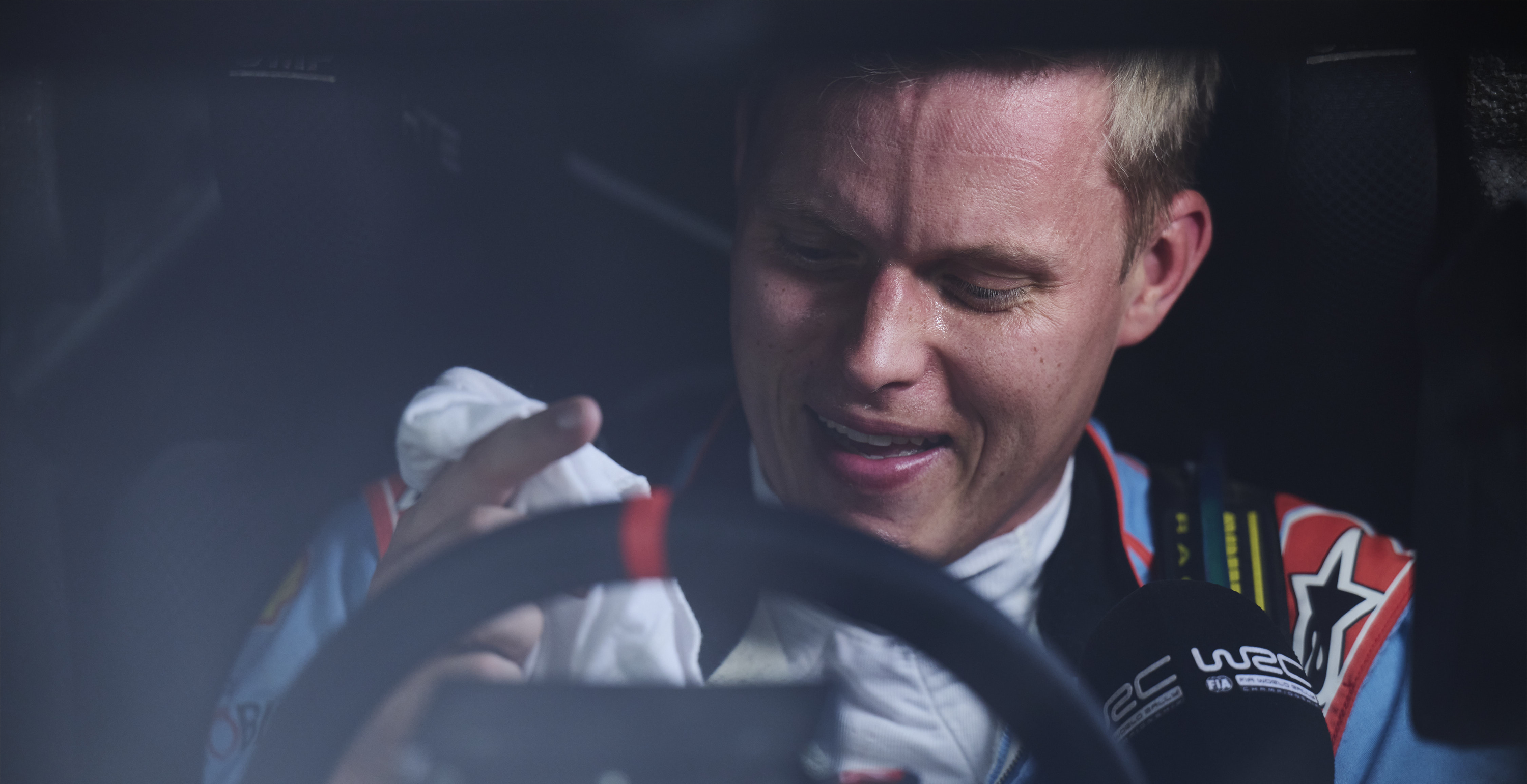 Ott Tanak getting interviewed in his car wearing an Alpinestars racing suit