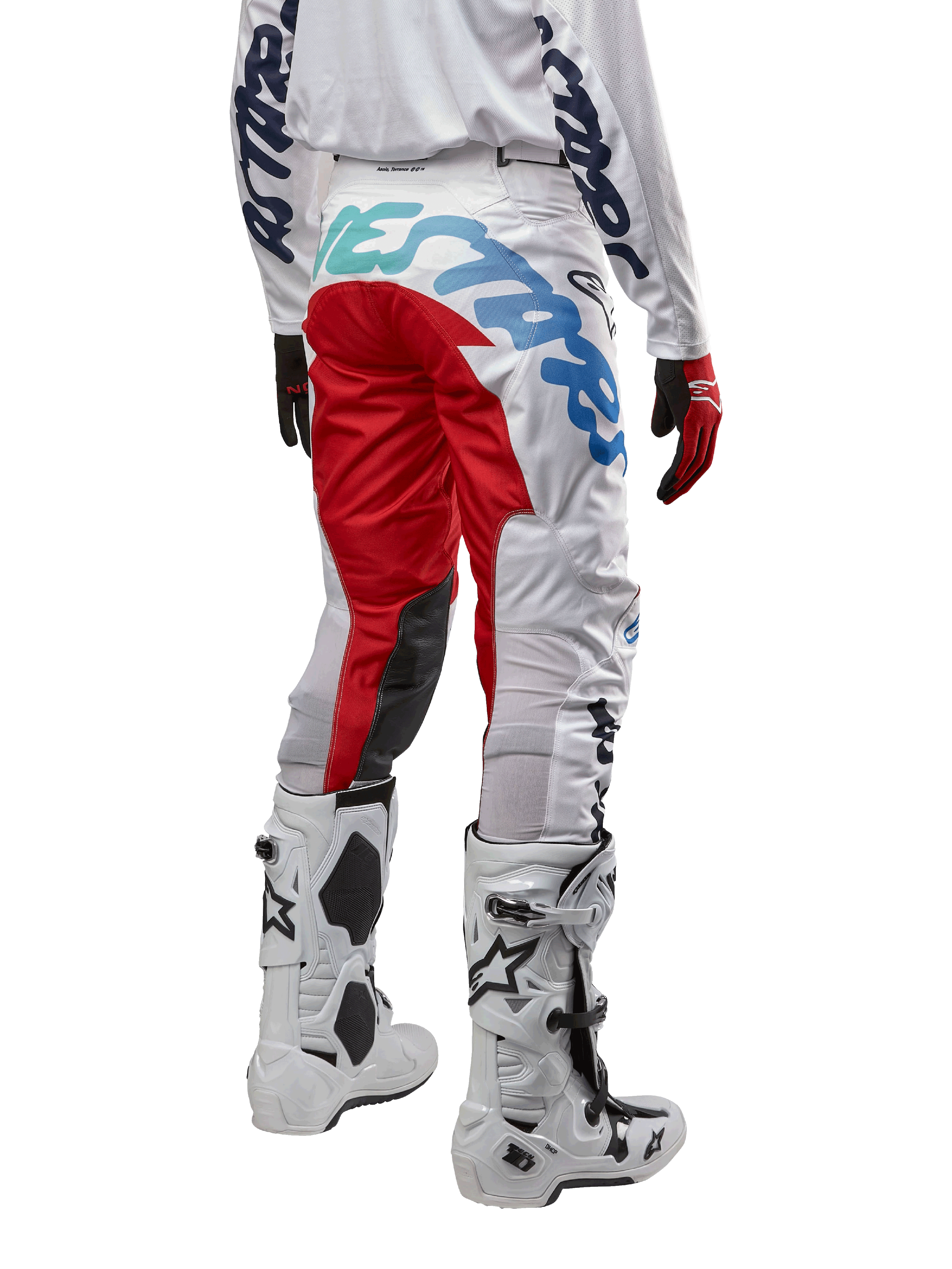 Alpinestars 2024 Racer Hana Pants, Motocross Pants, White Multicolor with red and blue accents, rear view showing large branding on the seat, worn with white and black motocross boots, designed for off-road performance and durability