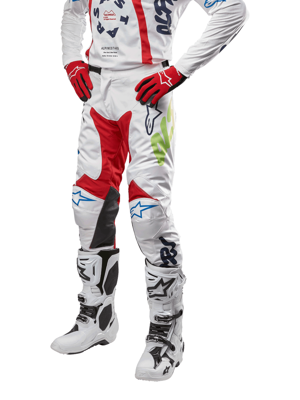 2024 Racer Hana Pants, Motocross Racing Pants, White with Red Blue and Lime Green accents, featuring protective design with leather knee panels, worn with matching jersey, red gloves, and white boots with buckles, sporty motorsports outfit