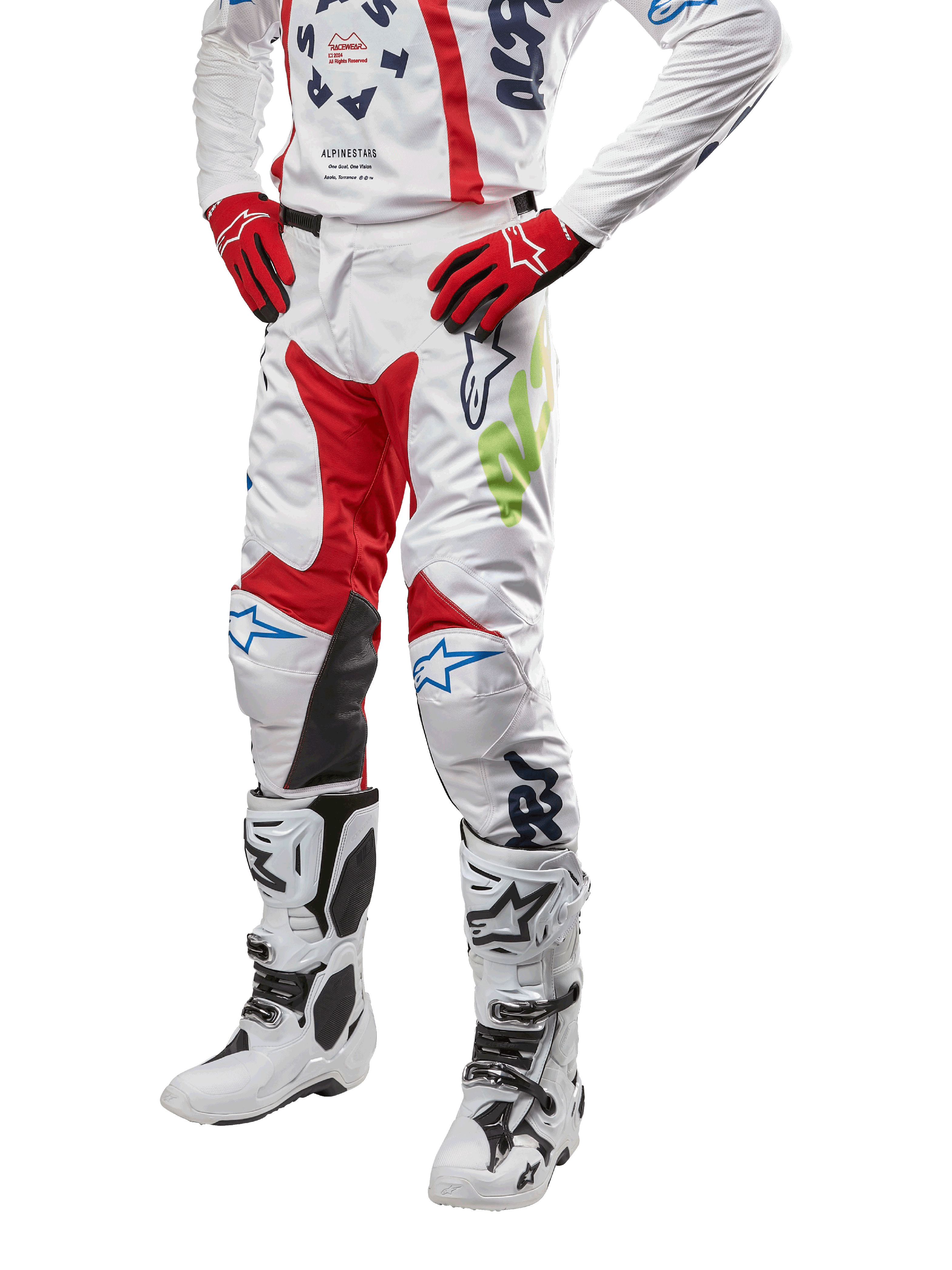 2024 Racer Hana Pants, Motocross Racing Pants, White with Red Blue and Lime Green accents, featuring protective design with leather knee panels, worn with matching jersey, red gloves, and white boots with buckles, sporty motorsports outfit