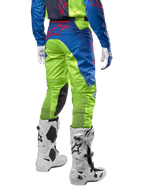 Alpinestars 2024 Racer Hoen Pants, Motocross Pants, Yellow Fluo and Blue Night Navy, back view, featuring a red Alpinestars logo, worn with matching jersey, white gloves, and white motocross boots, durable textile for off-road racing