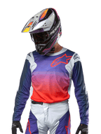 Alpinestars 2024 Racer Hoen Jersey, Motocross Jersey, Purple and Hot Orange Gradient with Dark Blue Sleeves, Light Gray shoulder panels, worn with matching racing pants and helmet, complete off-road riding gear