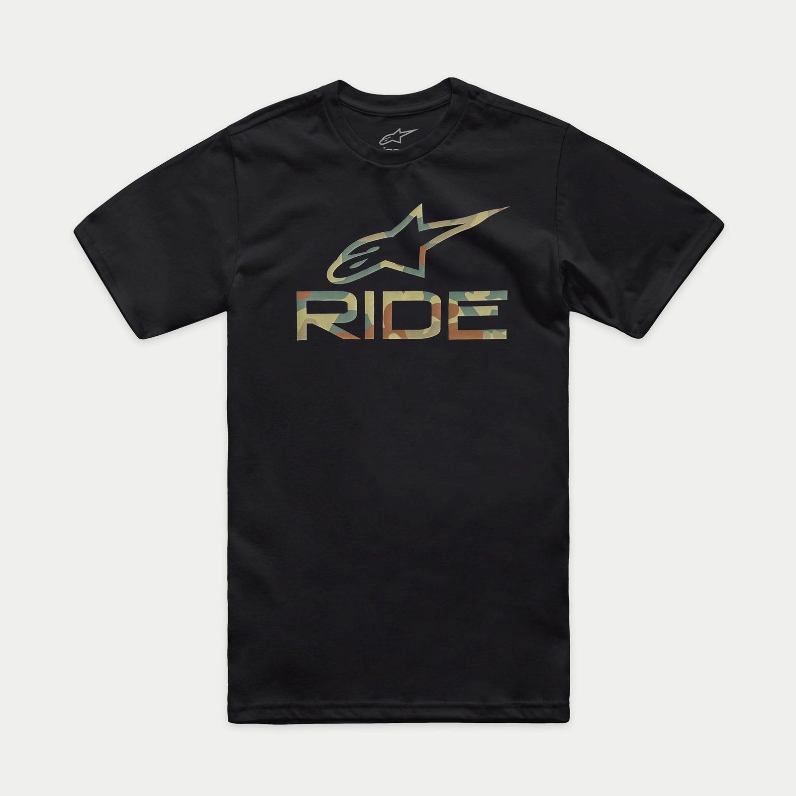 A person stands facing forward, wearing the Alpinestars Ride 4.0 Camo CSF Tee. The black T-shirt features a soft hand print with a colorful graphic logo and the word "RIDE" beneath. The person has short hair and a neutral expression. The background is plain black.