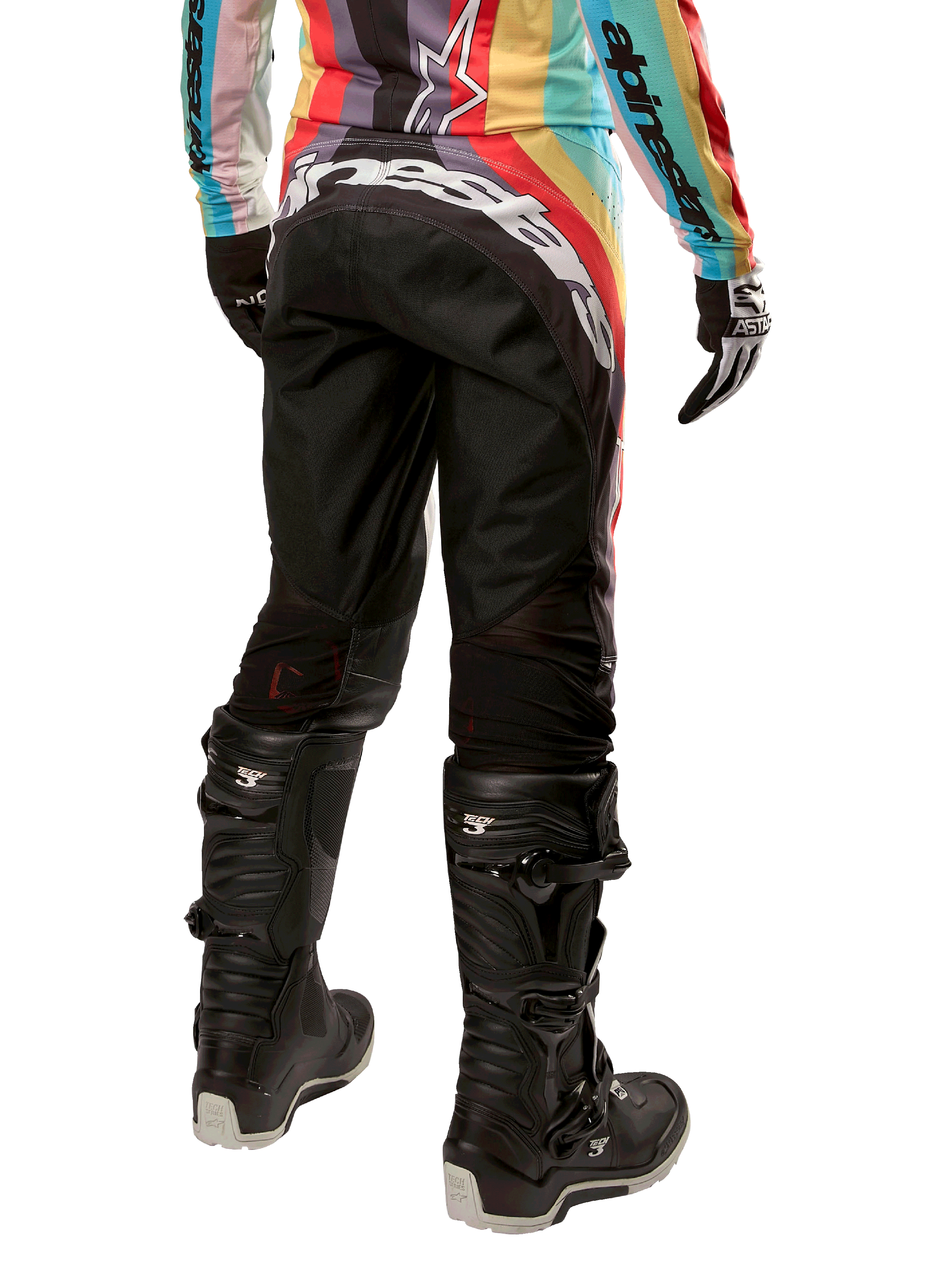 Alpinestars 2024 Stella Techstar, calças de motocross femininas, pretas multicolor, vista traseira com logótipo branco em destaque no assento, usadas com botas Tech 3 pretas e camisola multicolorida a condizer, equipamento profissional de corrida todo-o-terreno