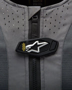 Alpinestars Tech-Air 5 System detail, magnetic operating flap with white star logo on gray perforated fabric.