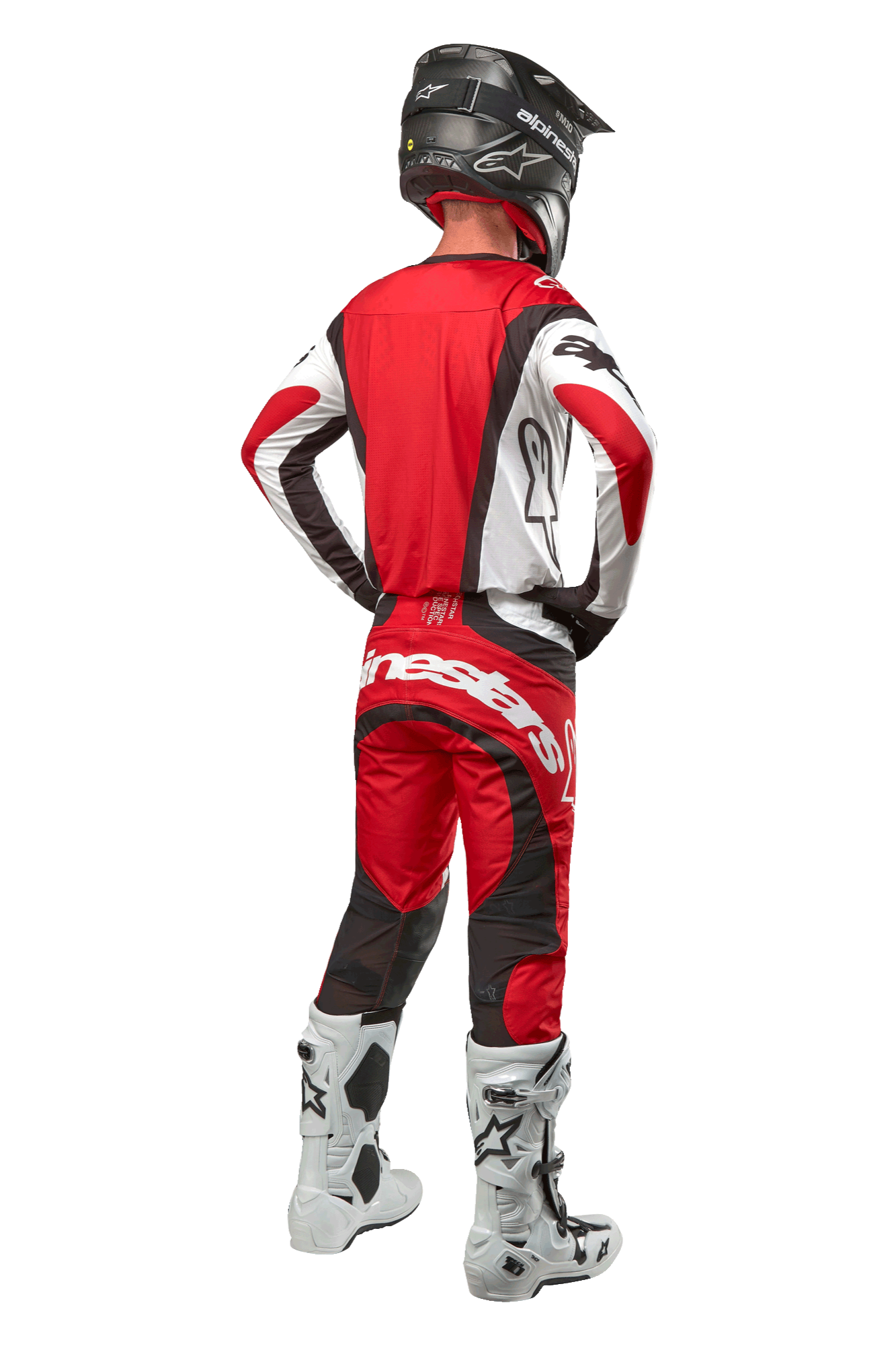 Calças Alpinestars Techstar Ocuri 2024, calças de motocross, Mars Red White Black, vista traseira de um piloto de motocross com equipamento de corrida completo, incluindo camisola a condizer, capacete preto e botas brancas e pretas, destacando a marca Alpinestars e a construção em tecido durável.