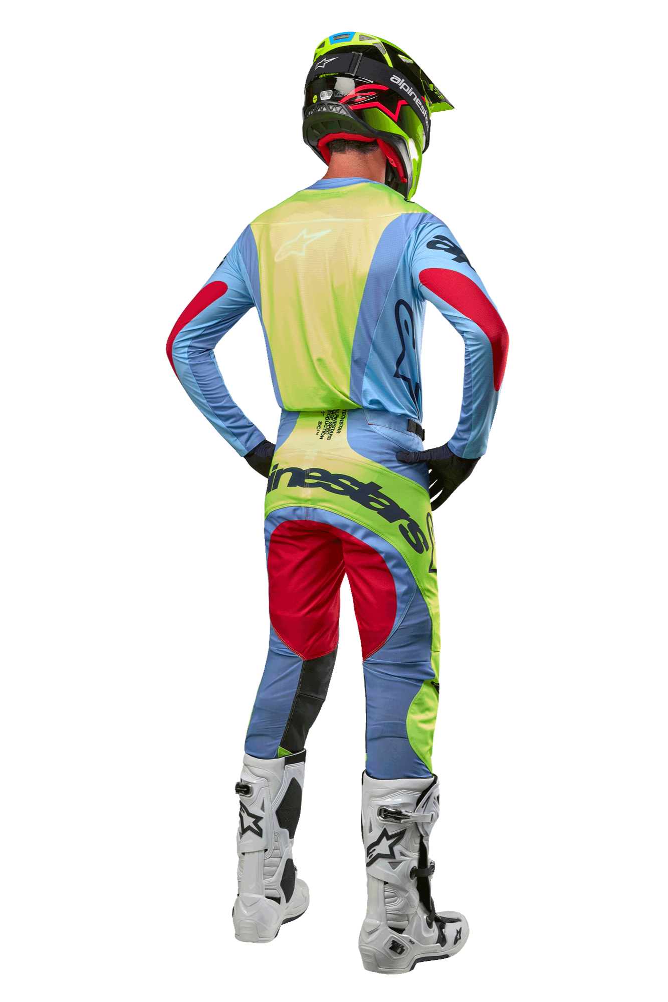 Motocross rider from behind wearing 2024 Techstar Ocuri Pants and matching jersey, Light Blue Yellow Fluo and Red Berry, white and black boots, black helmet with neon accents, coordinated Alpinestars gear for off-road racing
