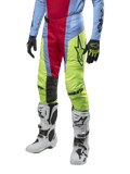 Alpinestars 2024 Techstar Ocuri Pants, Motocross Pants, Light Blue, Red Berry, and Neon Yellow, worn with matching gear and white boots, featuring bold Astars branding and a performance racing fit.