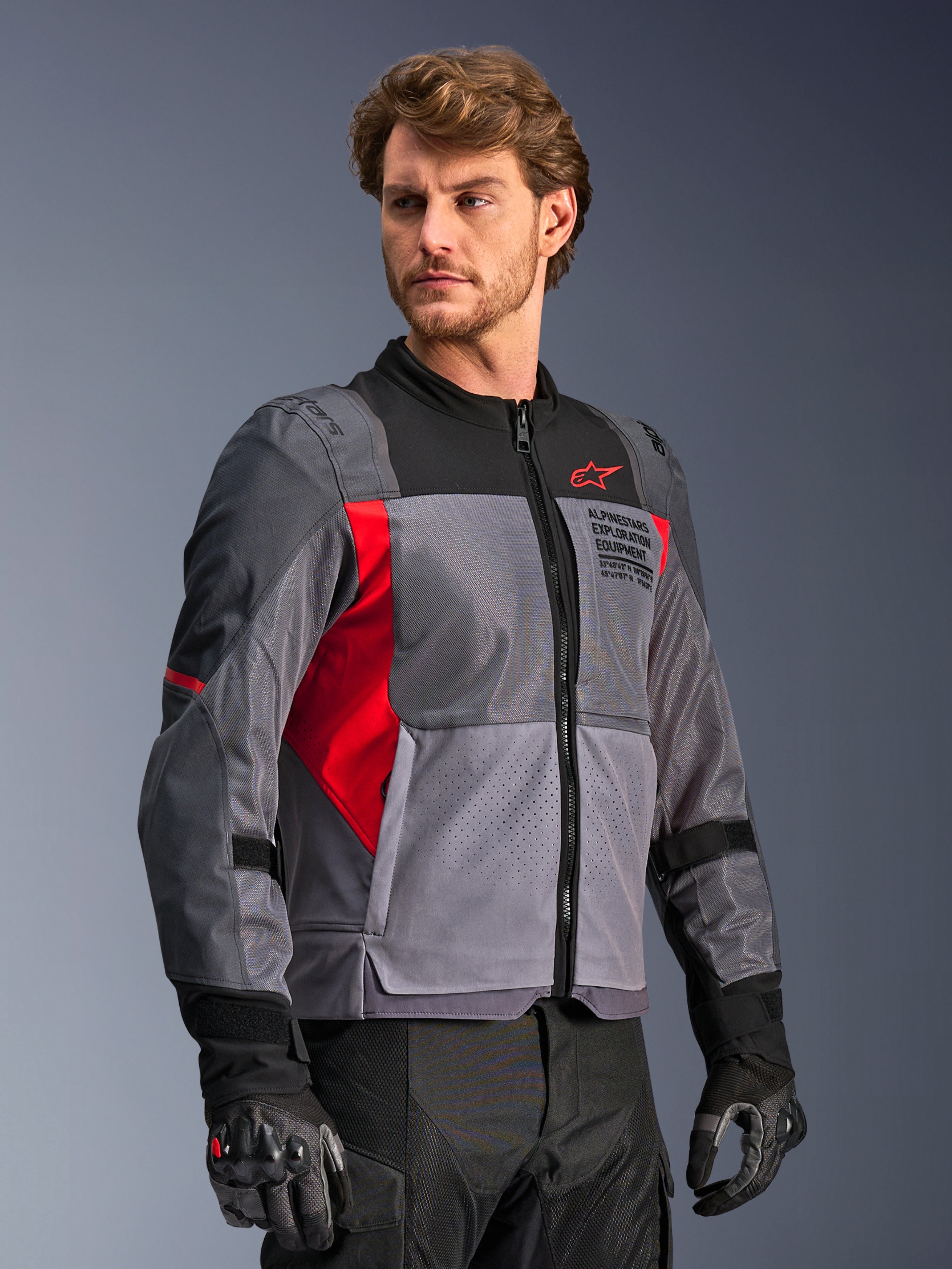 Alpinestars ST-2 Air Jacket, gray and red mesh motorcycle touring jacket with laser perforations, worn by a male model.