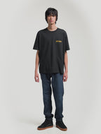 Alpinestars Latitude Oversized CSF Tee, Black Short Sleeve Sportswear T-Shirt, Unisex Oversized Fit, Yellow ASTARS Front Wordmark and Multi-Color Back Globe Graphic, Cotton-Poly Blend, On-Model Front and Back Views.