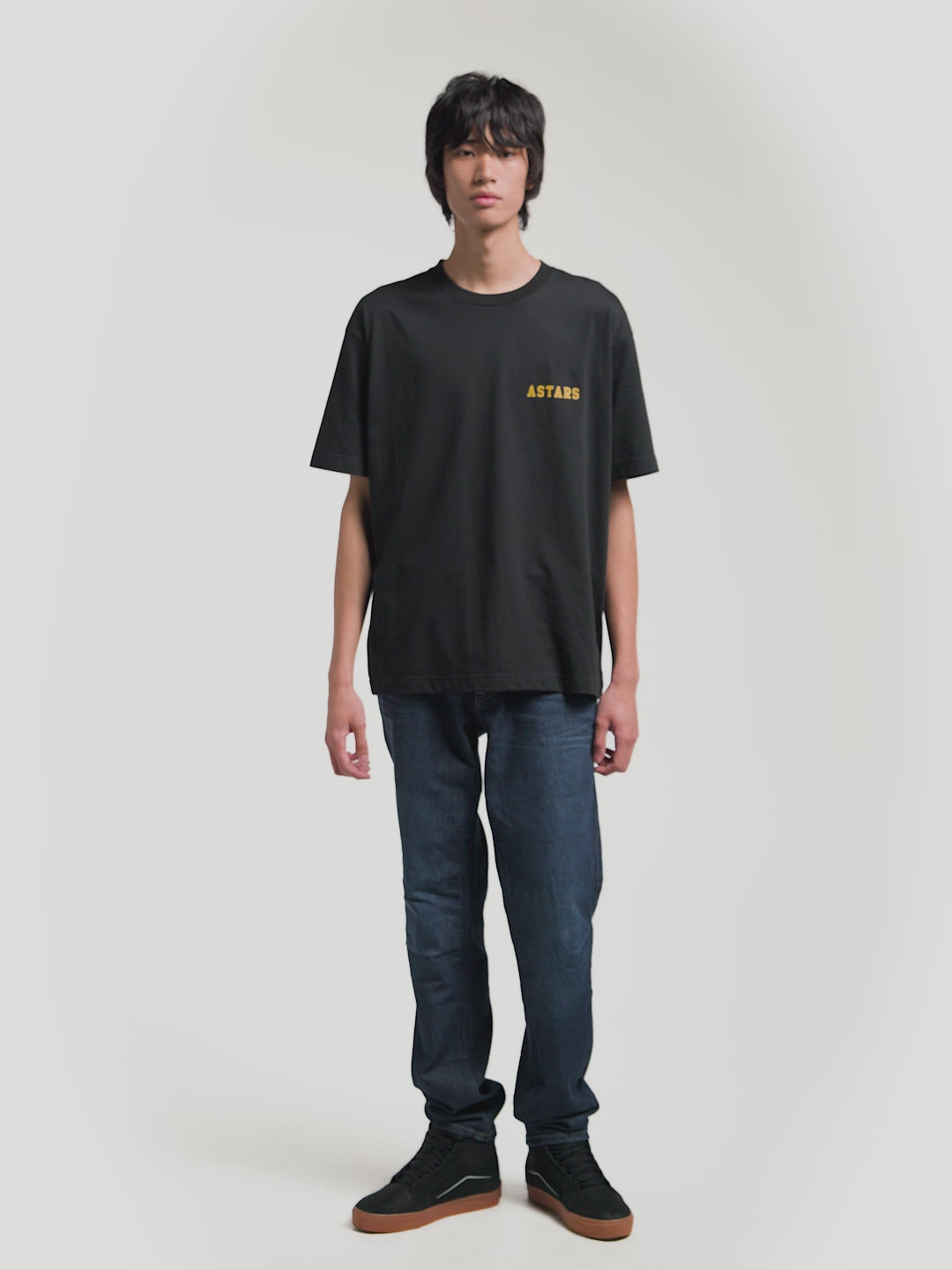 Alpinestars Latitude Oversized CSF Tee, Black Short Sleeve Sportswear T-Shirt, Unisex Oversized Fit, Yellow ASTARS Front Wordmark and Multi-Color Back Globe Graphic, Cotton-Poly Blend, On-Model Front and Back Views.