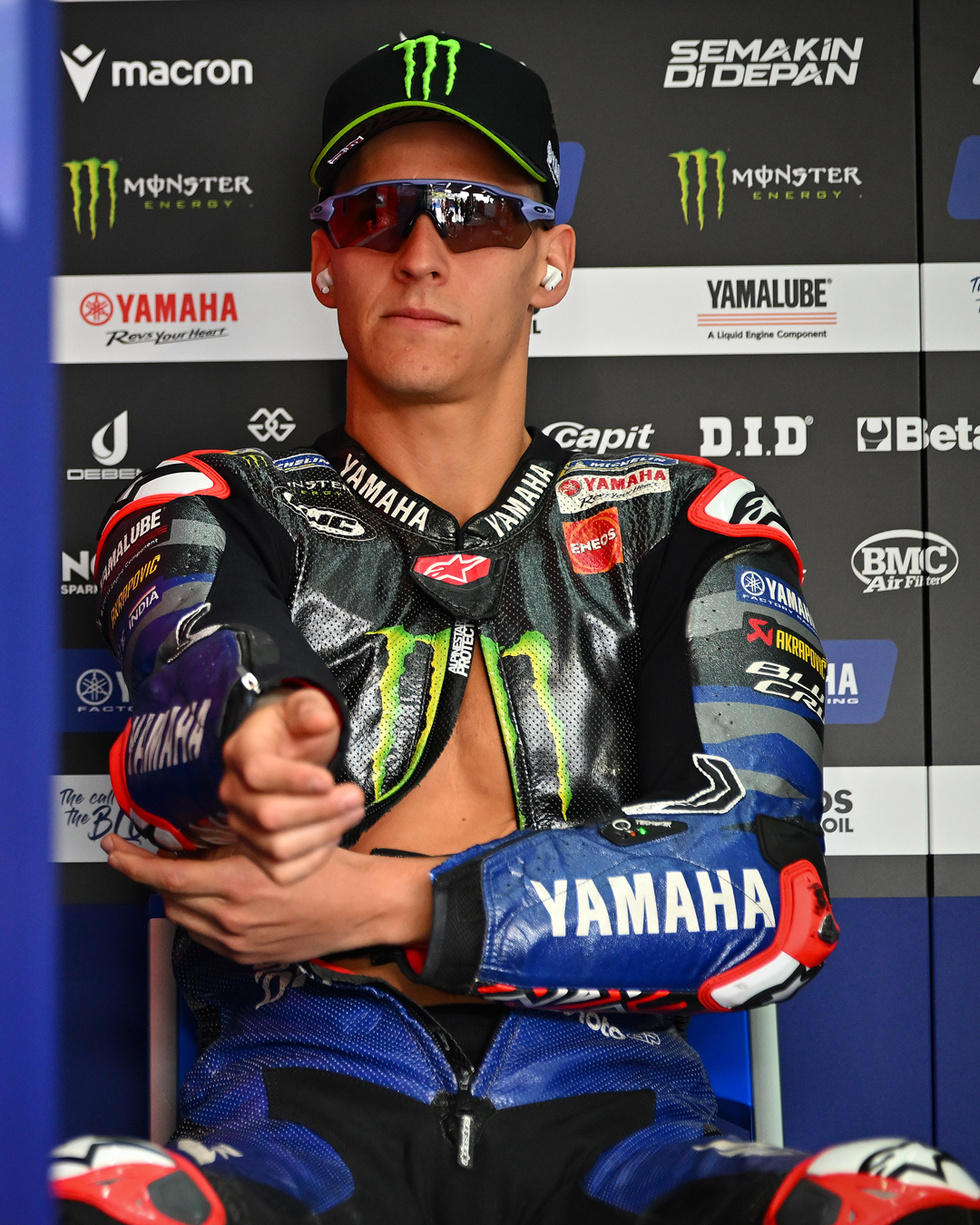 Fabio Quartararo sitting in the paddock wearing Alpinestars gear