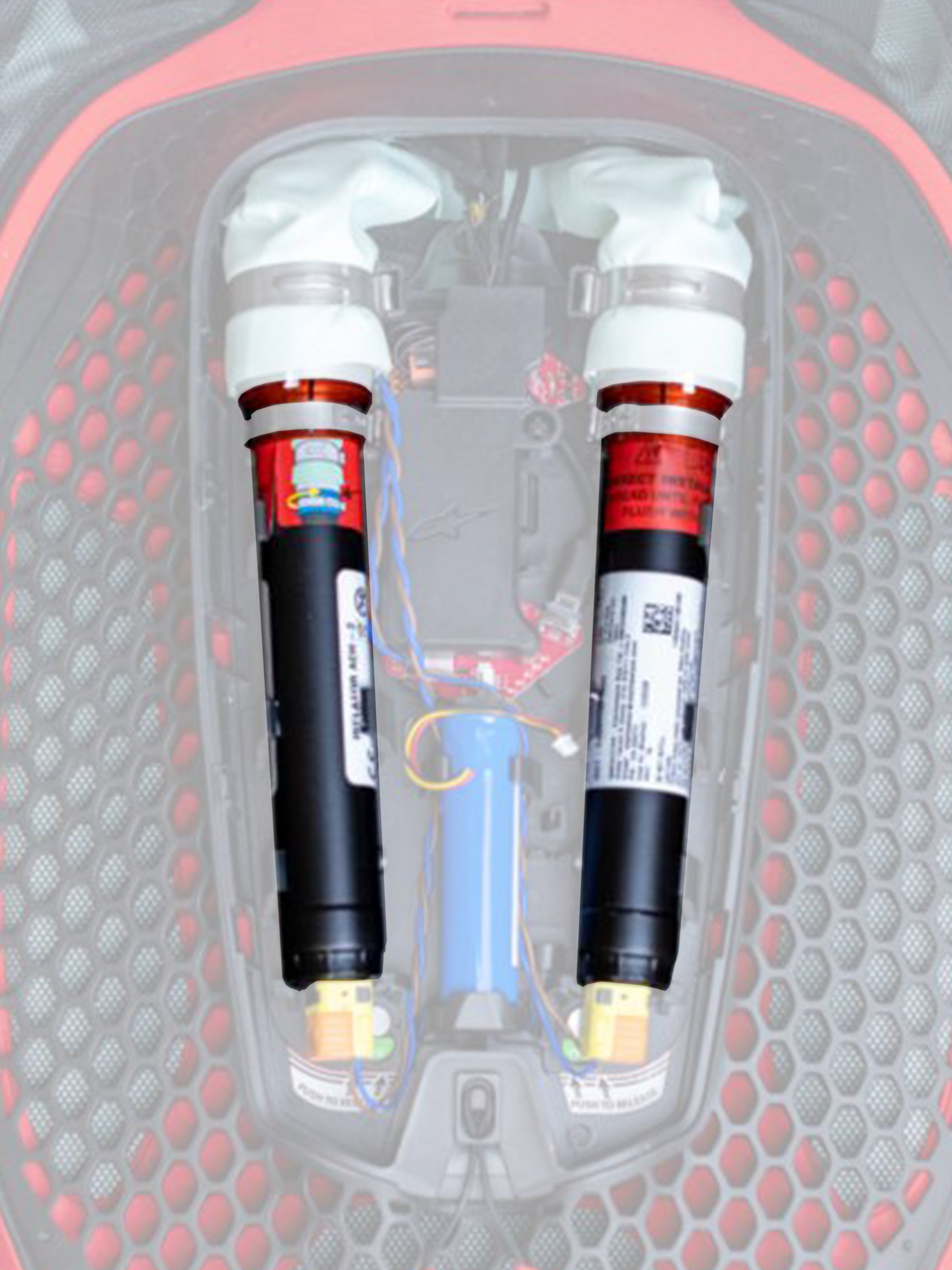 Alpinestars Tech-Air 7X & Off-Road Replacement Canister Kit, Airbag Replacement Canisters, Black with white tops and orange bands, dual argon canisters shown installed in a red and black honeycomb-patterned electronic airbag system with colored wiring